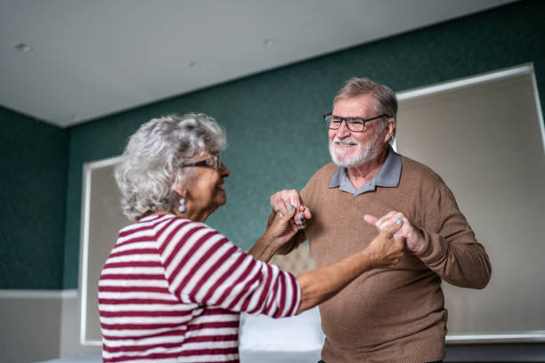 istock Senior couple dancing at home 1397342916