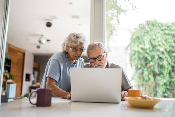 istock Senior couple talking about home finances and using the laptop at home 1397343072