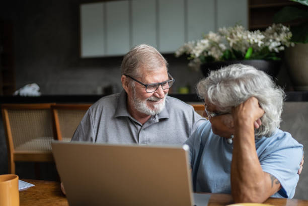 istock Happy senior couple using the laptop at home 1397343627