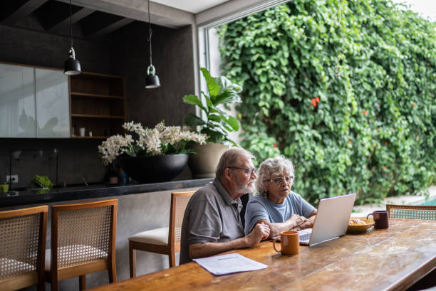 istock Senior couple talking about home finances and using the laptop at home 1397343631