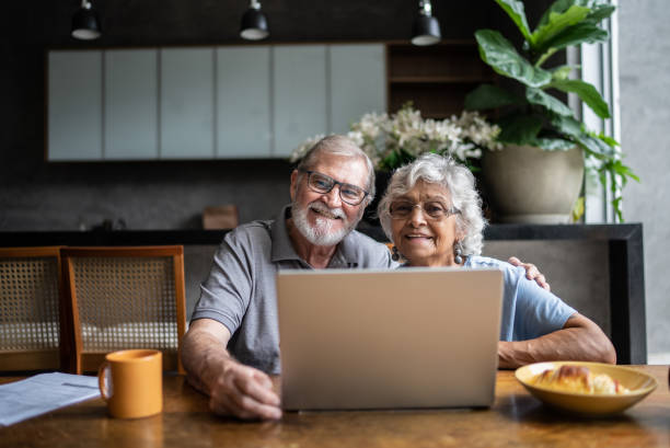 istock Portrait of senior couple doing home finances using laptop 1397343676