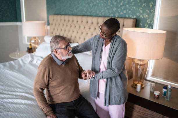 istock Home caregiver helping patient standing up 1397344251