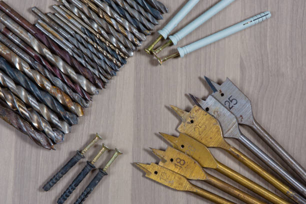 istock Different tools on a wooden background. drill, Wood drill, concrete drill bit 1397344857