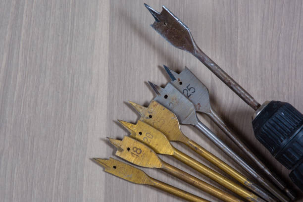 istock Different tools on a wooden background. drill, Wood drill, concrete drill bit 1397344858
