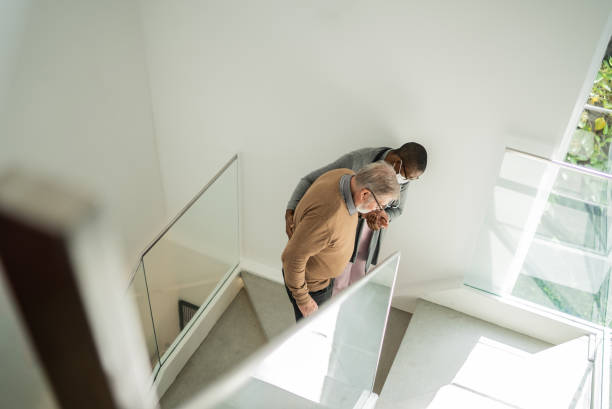 istock Nurse helping patient walking on the stairs 1397345134