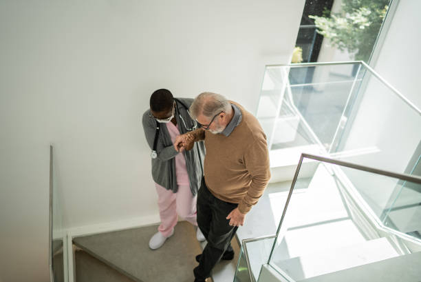 istock Nurse helping patient walking on the stairs 1397345142