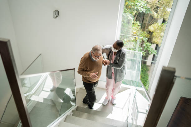 istock Nurse helping patient walking on the stairs 1397345149
