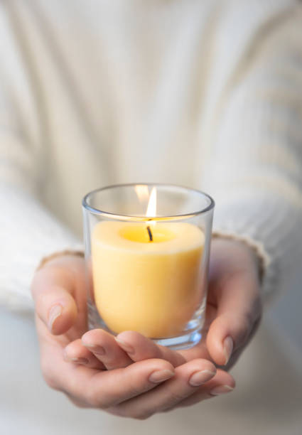 istock A candle is burning in a woman's palms. Candle heat. 1397345152
