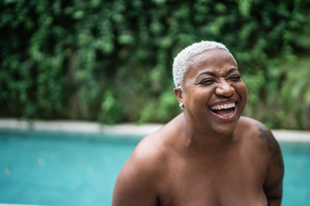 Mature woman laughing at home