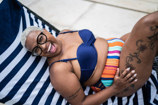 Mature woman laughing in a pool at home