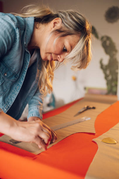 istock Woman tailor working from home and tailoring beautiful clothes 1397346738