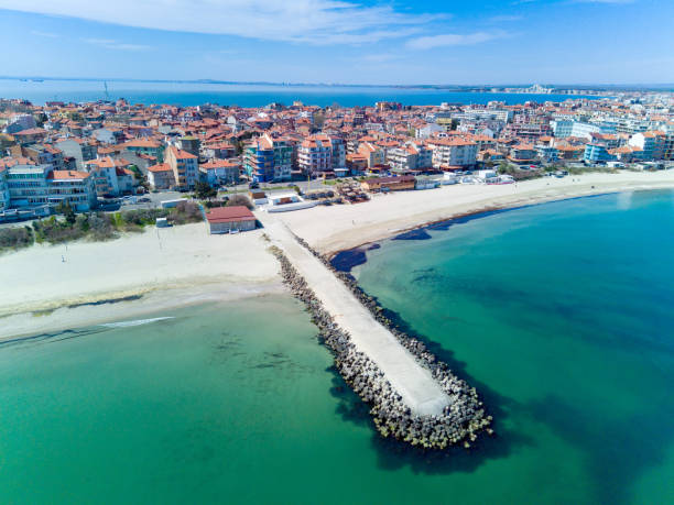 Panoramic view from a height above the town of Pomorie with houses and streets washed by the Black Sea in Bulgaria Panoramic bird's eye view over small ancient resort town of Pomorie with old European small houses and quiet calm empty streets, washed by the sea spring turquoise Black Sea on clear day in Bulgaria pomorie stock pictures, royalty-free photos & images