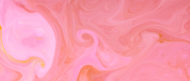Pink coral color background. Fluid art texture with pastel colors. Pink peach blurred shapes on a liquid surface