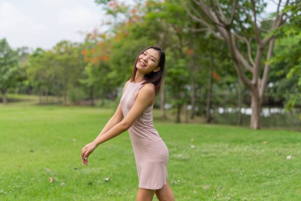 istock Young asian lady chill and relaxing in a park 1397348784