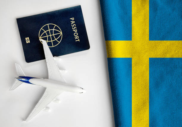 flagge von schweden mit pass und spielzeugflugzeug. - passport sweden customs europe stock-fotos und bilder