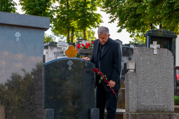 istock Mature man mourning a deceased loved one on cemetery. 1397350138
