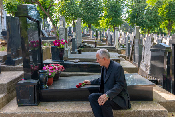 istock Mature man mourning a deceased loved one on cemetery. 1397350139