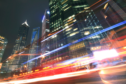 Modern office building background of night with light trails  in Shanghai