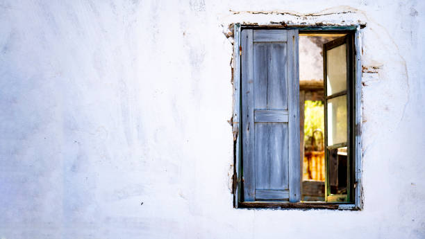 istock Banner of an Antique window on a white old wall and  light from an inside window. 1397351248