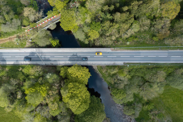 istock Cars crossing a small river using a modern bridge 1397358704