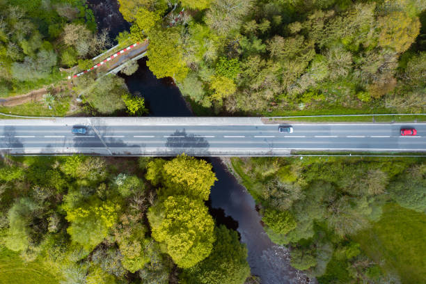 istock Vehicles using a road bridge to cross a river 1397358768