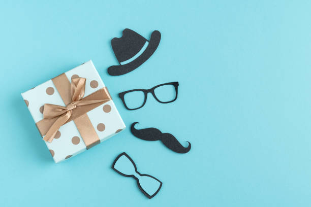 istock Figures on cut paper on blue background with gift box. Father's day concept. Man's day. Copy space. 1397358824