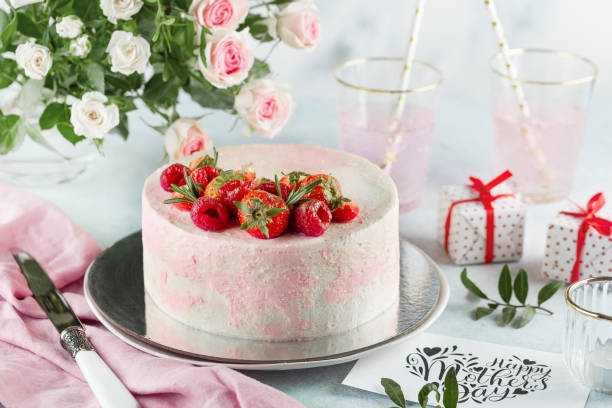 festive cake decorated with strawberries on a light background. Sweets concept for Mothers Day stock photo