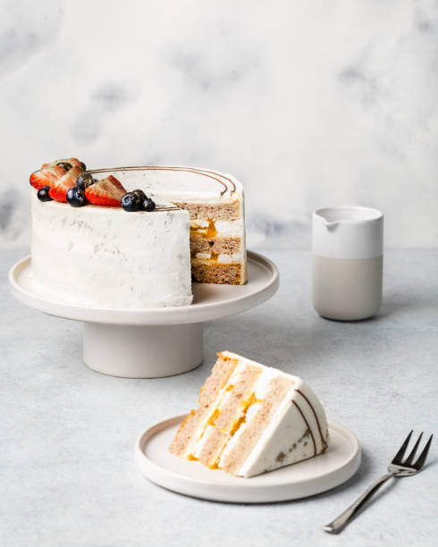 istock festive white cake decorated with berries on a light background. Sweets concept 1397361079