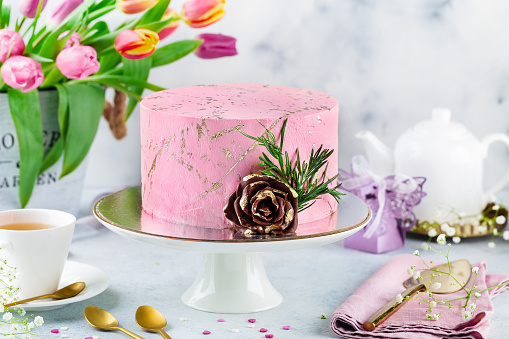 festive pink cake on a light background. Sweets concept