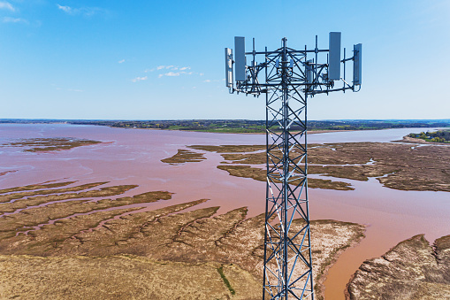 Aerial drone view of a cellular/data tower & antennas.