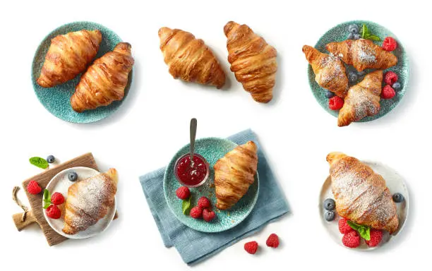 Photo of freshly baked croissant on blue plate