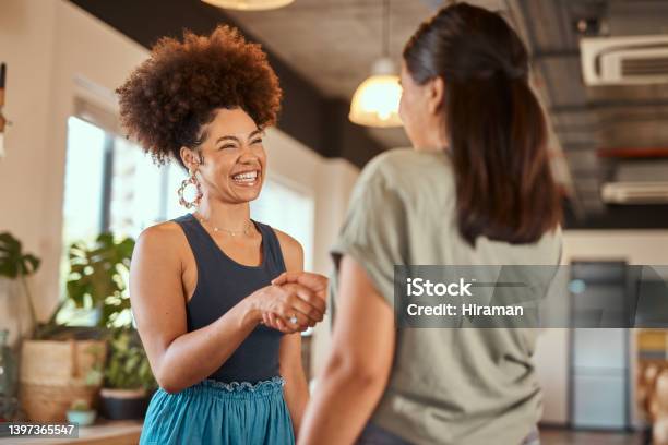 Beautiful Mixed Race Creative Business Woman Shaking Hands With A Female Colleague Two Young Female African American Designers Making A Deal A Handshake To Congratulate A Coworker On Their Promotion Stock Photo - Download Image Now