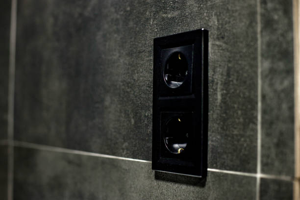 istock New black rosette on a ceramic tile of black color. Electrical outlet. Bathroom. 1397366323