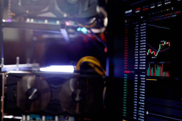 Graphics cards in rig for ethereum mining farm on background Stock Market ETH Chart