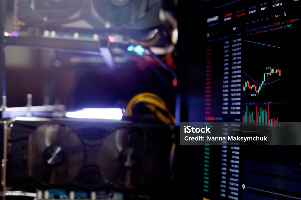 Graphics cards in rig for ethereum mining farm on background Stock Market ETH Chart Graphics cards in rig for ethereum mining farm on background Stock Market ETH Chart. Banking Stock Photo