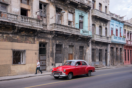 Havana, Cuba - January 20, 2016: Demolished buildings and an old American classic car in the city center