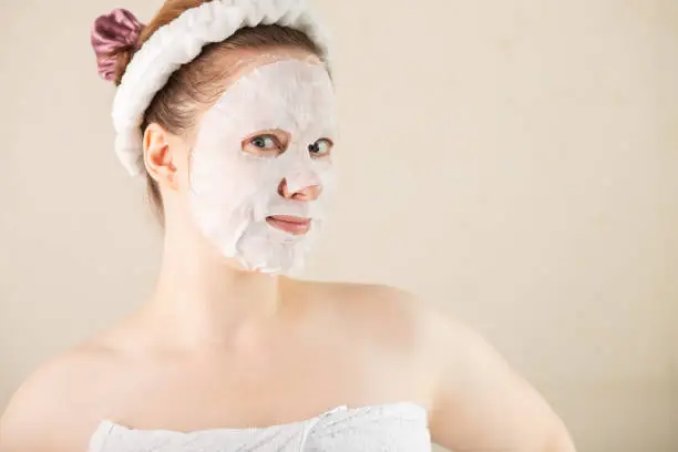 Photo of bubble facial mask, face skin care, moisturizing cosmetics for beauty and health, a woman in the bathroom in the morning