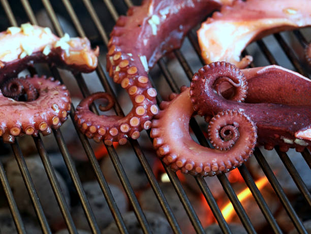 istock octopus tentacles on the grill grate over glowing coals on the grill, close up 1397371028