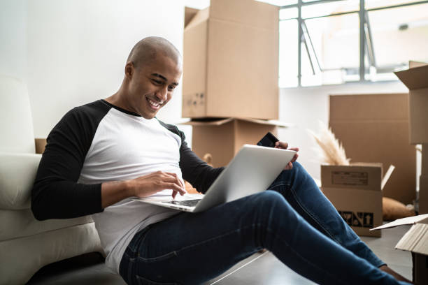 istock Young man doing an online shopping for new home 1397371398