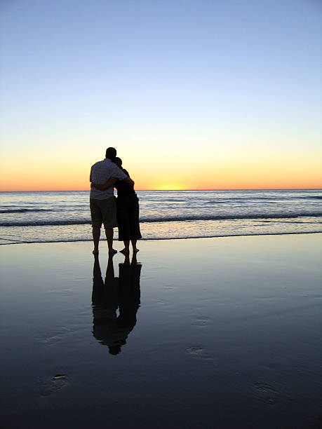 istock Couple Embracing on a Beach at Sunset 139737145