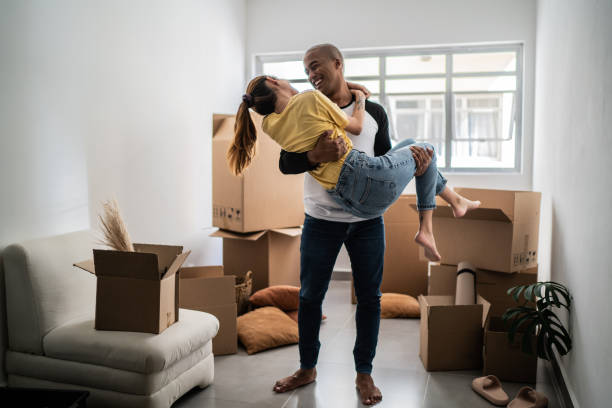 istock Happy young couple moving house, packing moving boxes 1397372979