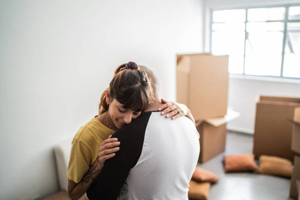 Couple embracing in their new home