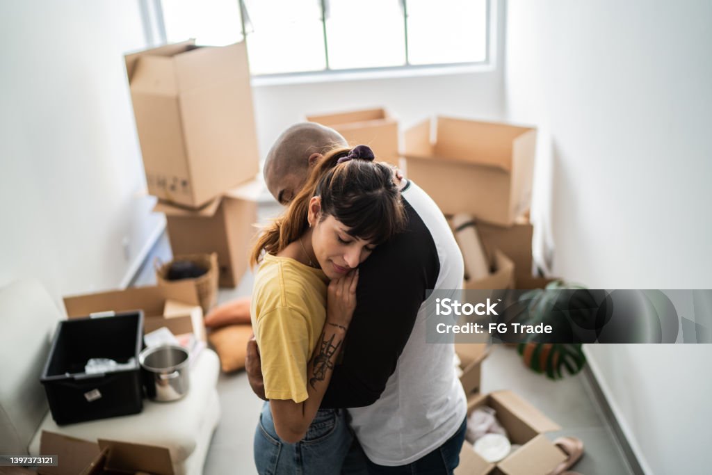 Couple embracing leaving home Eviction Stock Photo