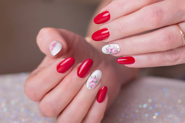 istock Beautiful female hands with pink manicure, peonies design 1397373166