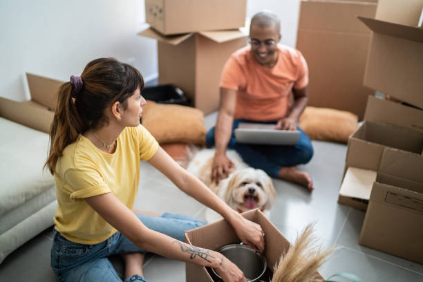 istock Young couple packing and moving boxes at home 1397373409
