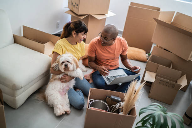 istock Young couple packing and moving boxes at home 1397373436