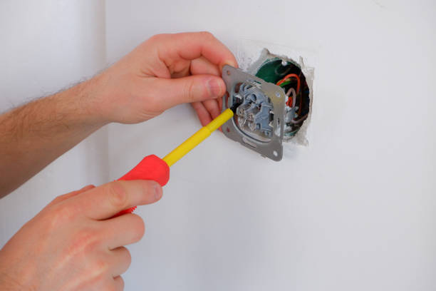 istock The electrician unscrews the switch with a screwdriver. Close-up on the hands. The routine work of an electrician. Checking contacts. Switch replacement. 1397373458
