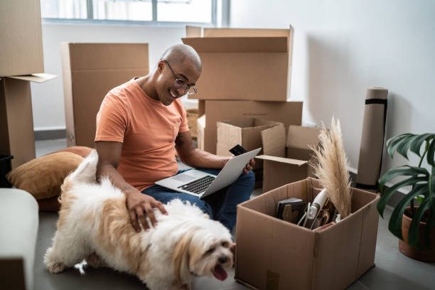 istock Young man doing online shopping using laptop at new home 1397373573