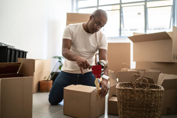 istock Young man packing and moving boxes at home 1397373667