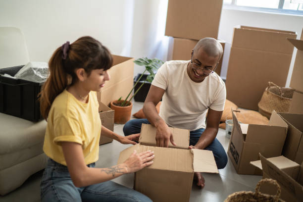 istock Young couple packing and moving boxes at home 1397373674
